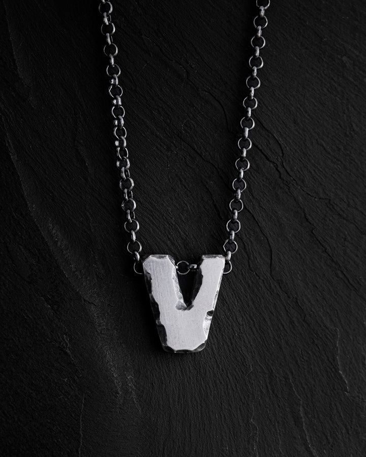 Letter V pendant on a chain
