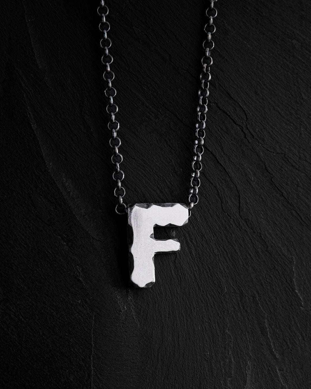 Letter F pendant on a chain