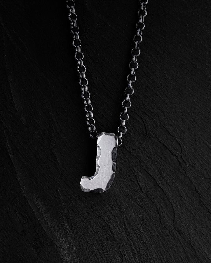Letter J pendant on a chain