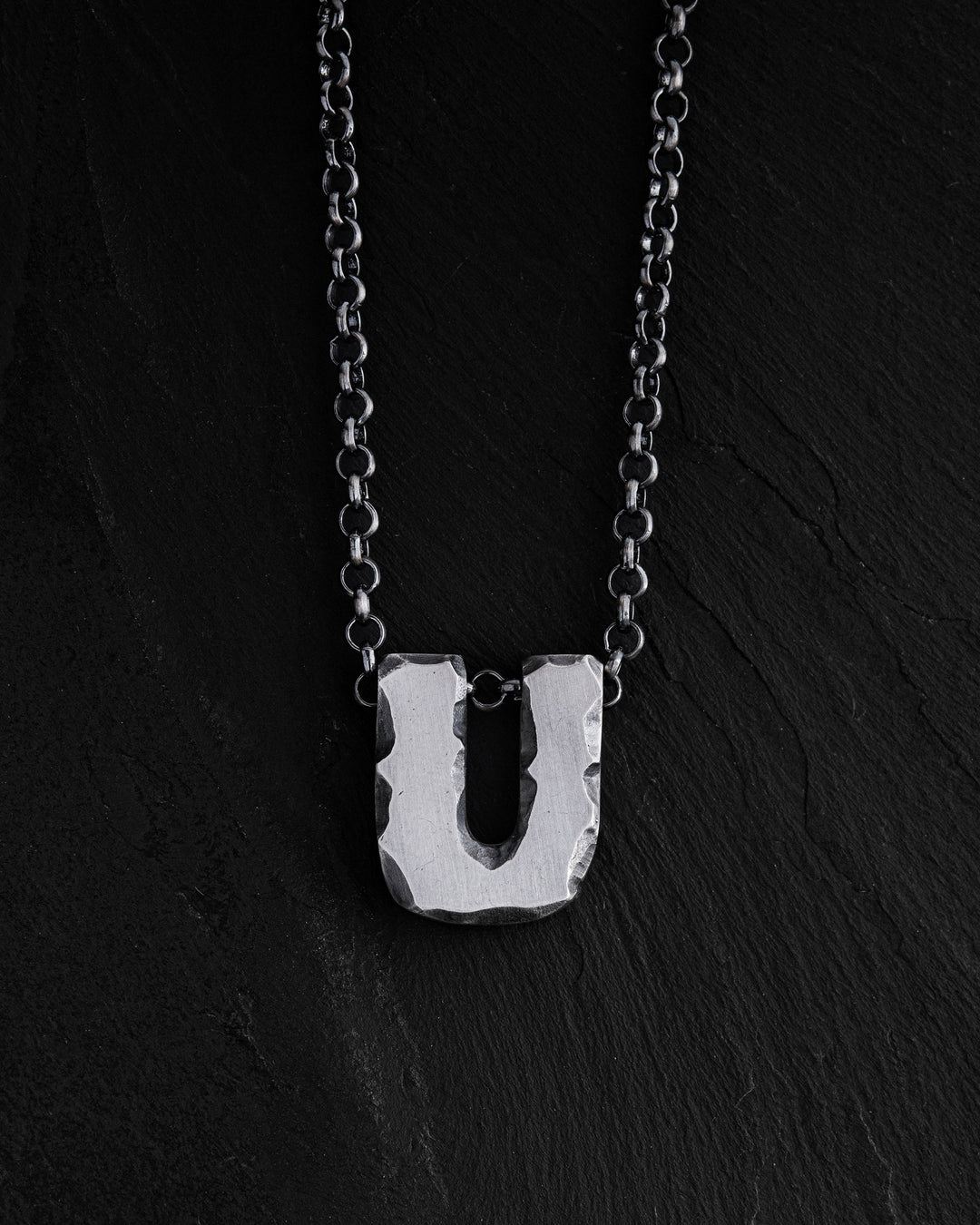 Letter U pendant on a chain