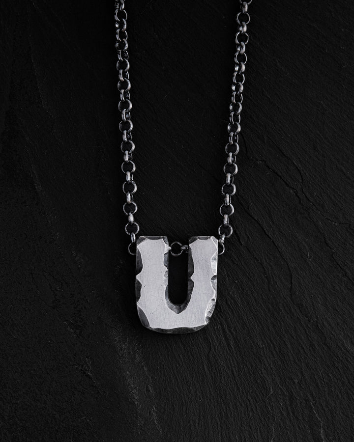 Letter U pendant on a chain