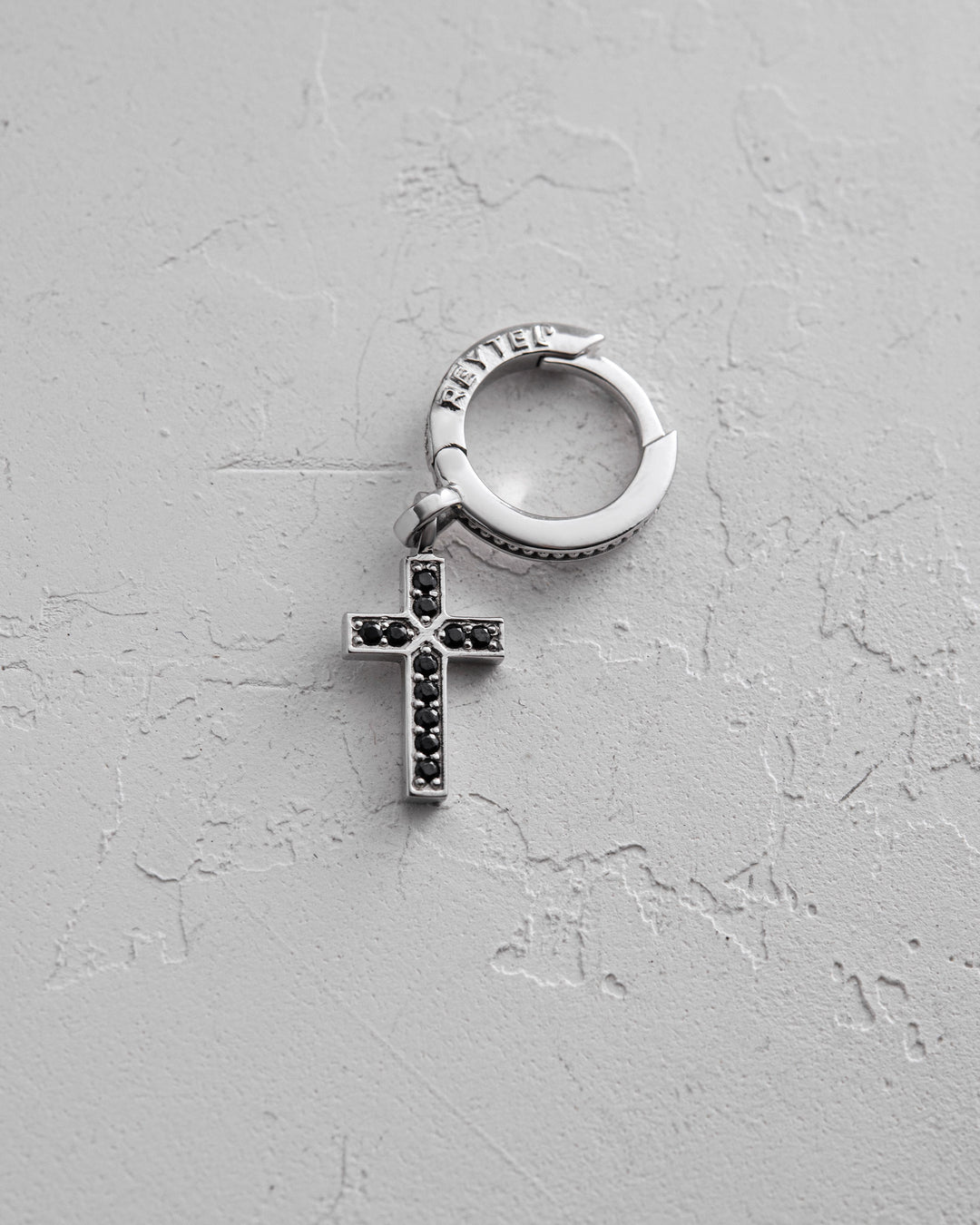 14k white gold single earring CROSS. BLACK STONES