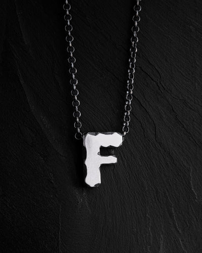 Letter F pendant on a chain