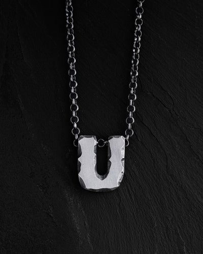 Letter U pendant on a chain